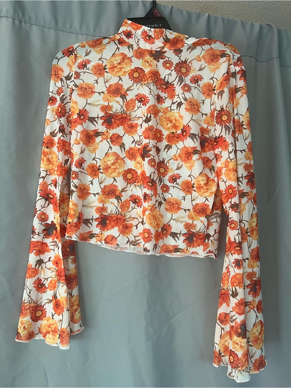 Mock Neck Floral Crop Top in Orange - Assembly Label
